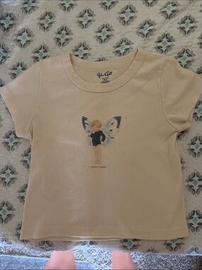 Brandy Melville Cream Tee with Fairy Graphic and Navy Wing Accents